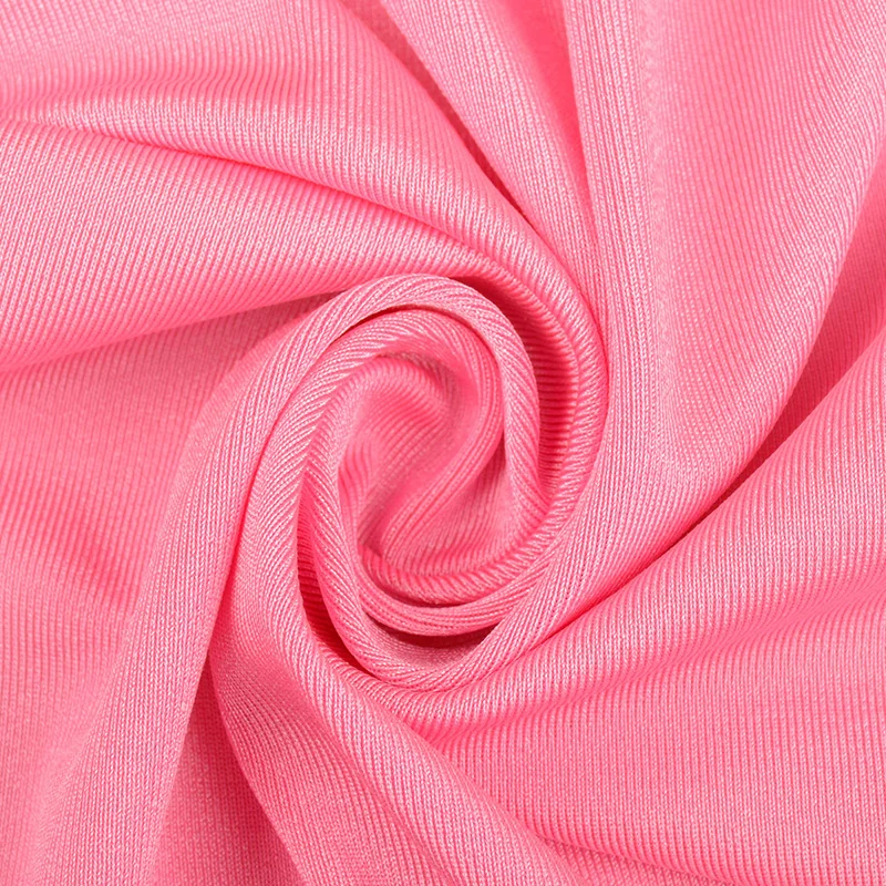 Close-up of pink stretch swimwear fabric folded into a swirl